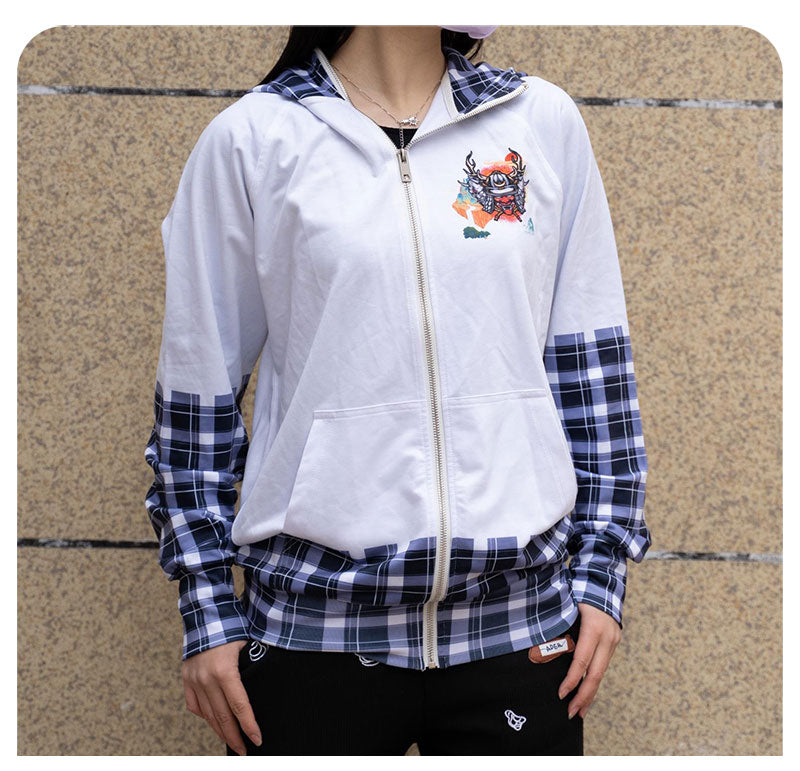 A model standing outdoors and wearing the personalized white custom zip-up hoodie with a blue checkered plaid lower hem.